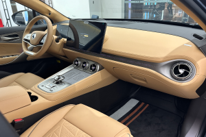 Das Innere eines Mercedes-Benz S-Klasse Limousinen auf der IAA in Frankfurt, mit einem Lenkrad, Armaturenbrett, Bildschirmen, Knöpfen, Sitzen, Seitenspiegeln und Glasfenstern, durch die Menschen, Gebäude und andere Objekte im Hintergrund sichtbar sind.